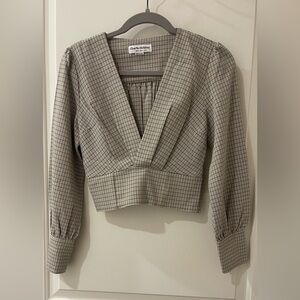 Plaid tan and black top. Cropped and low cut with an expandable back.
